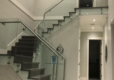 Direct Glass 12mm Inside Glass Railing with standoffs grey walls